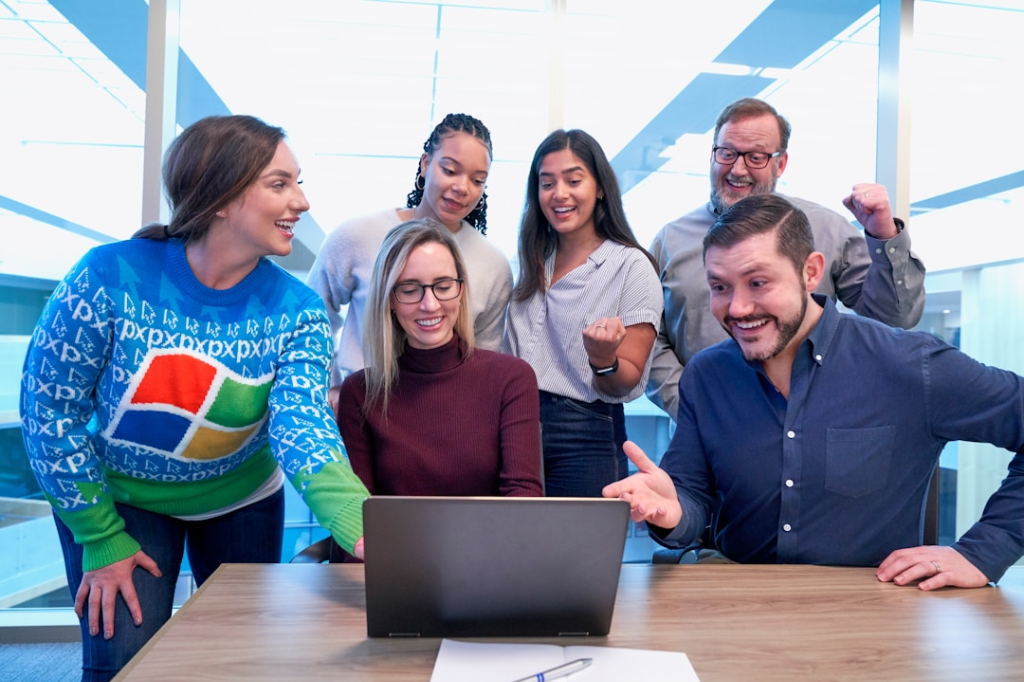 Group gathered around laptop